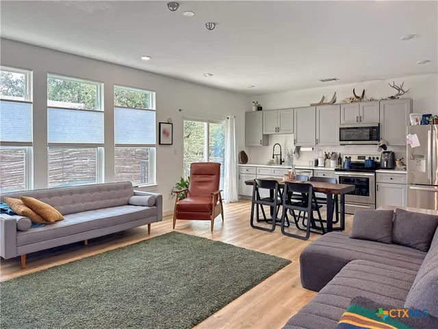 a living room with furniture and a large window
