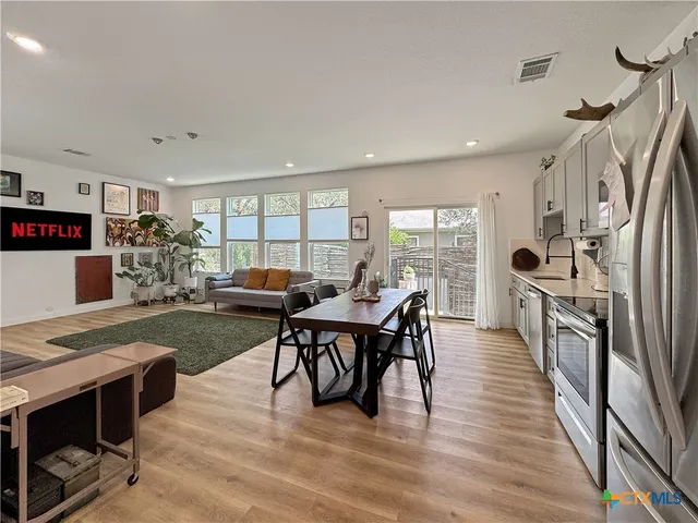 a view of a dining room with furniture and wooden floor