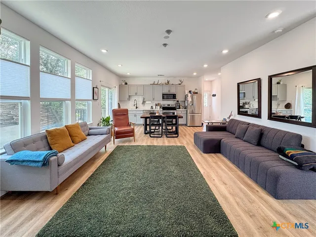 a living room with furniture and a large window