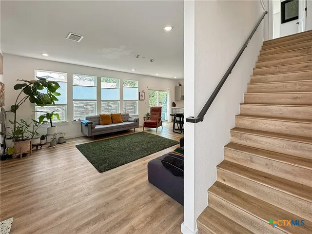 a living room with furniture and a rug