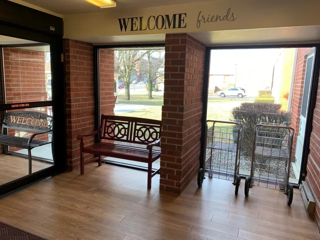 a view of a room with furniture and wooden floor