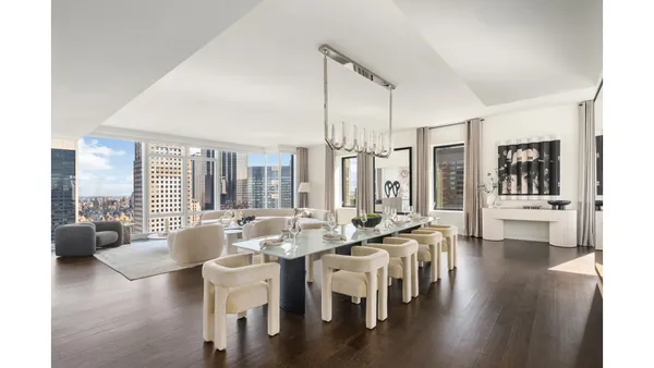 a large room with lots of furniture and a chandelier