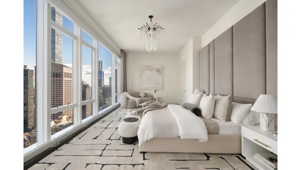 a living room with furniture and large windows