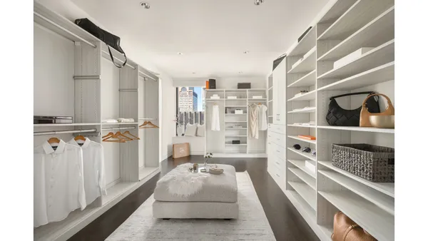 a bedroom with a bed and walk in closet