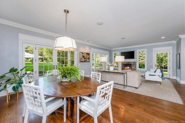 a dining room with furniture window and wooden floor