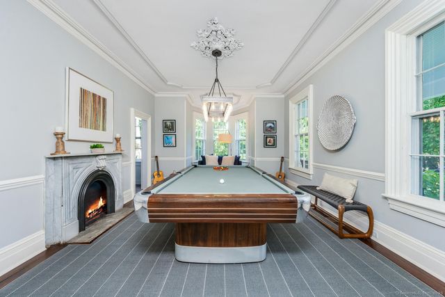 a living room with furniture a fireplace and a window