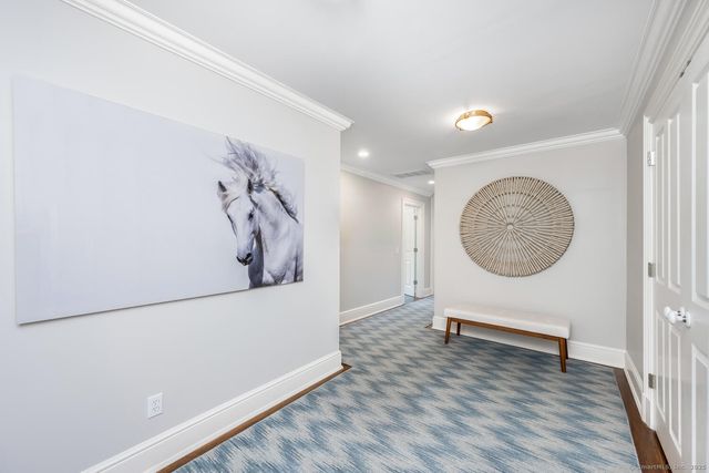 a view of a livingroom with wooden floor and a large window