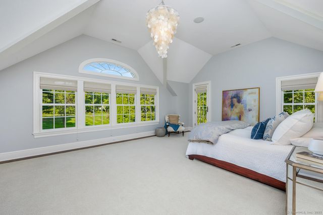 a spacious bedroom with a large bed and a large window