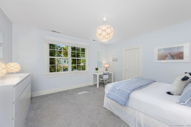 a spacious bedroom with a bed and a window