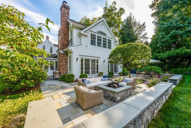 a view of a house with pool and sitting area