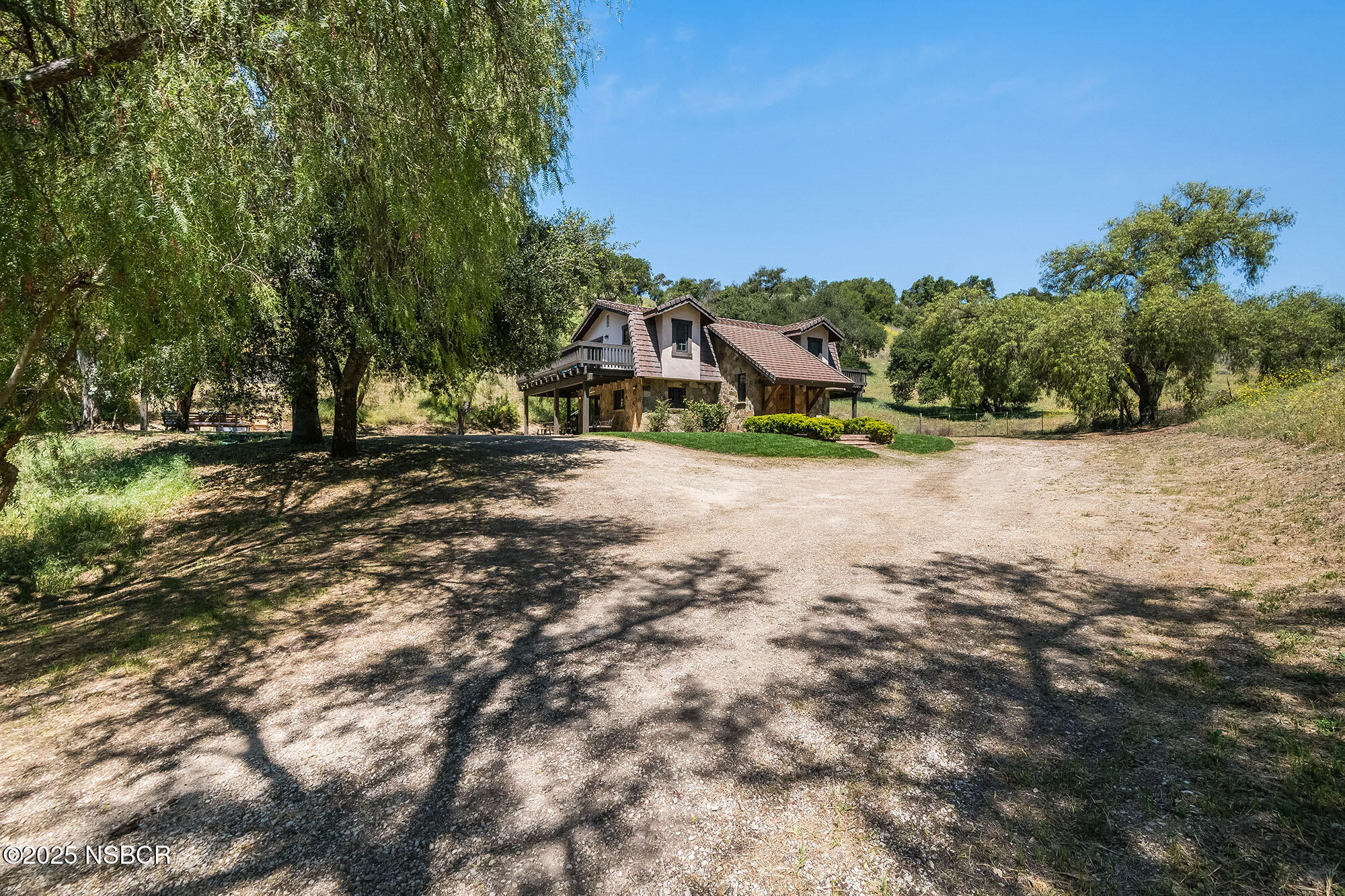 3333-3349 Long Valley Road Santa Ynez, CA 93460 - Photo 23 of 97 a view of a yard with a house in the background