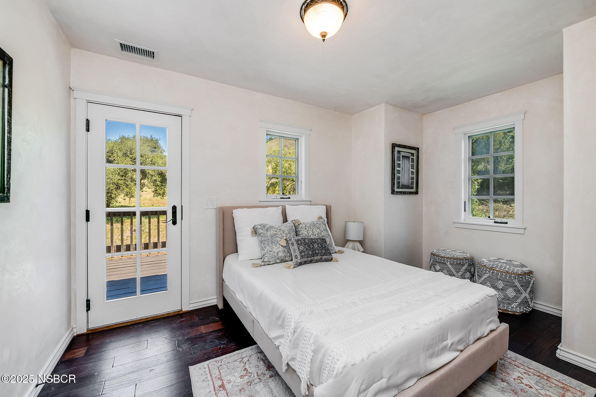 3333-3349 Long Valley Road Santa Ynez, CA 93460 - Photo 68 of 97 a bedroom with a bed and wooden floor