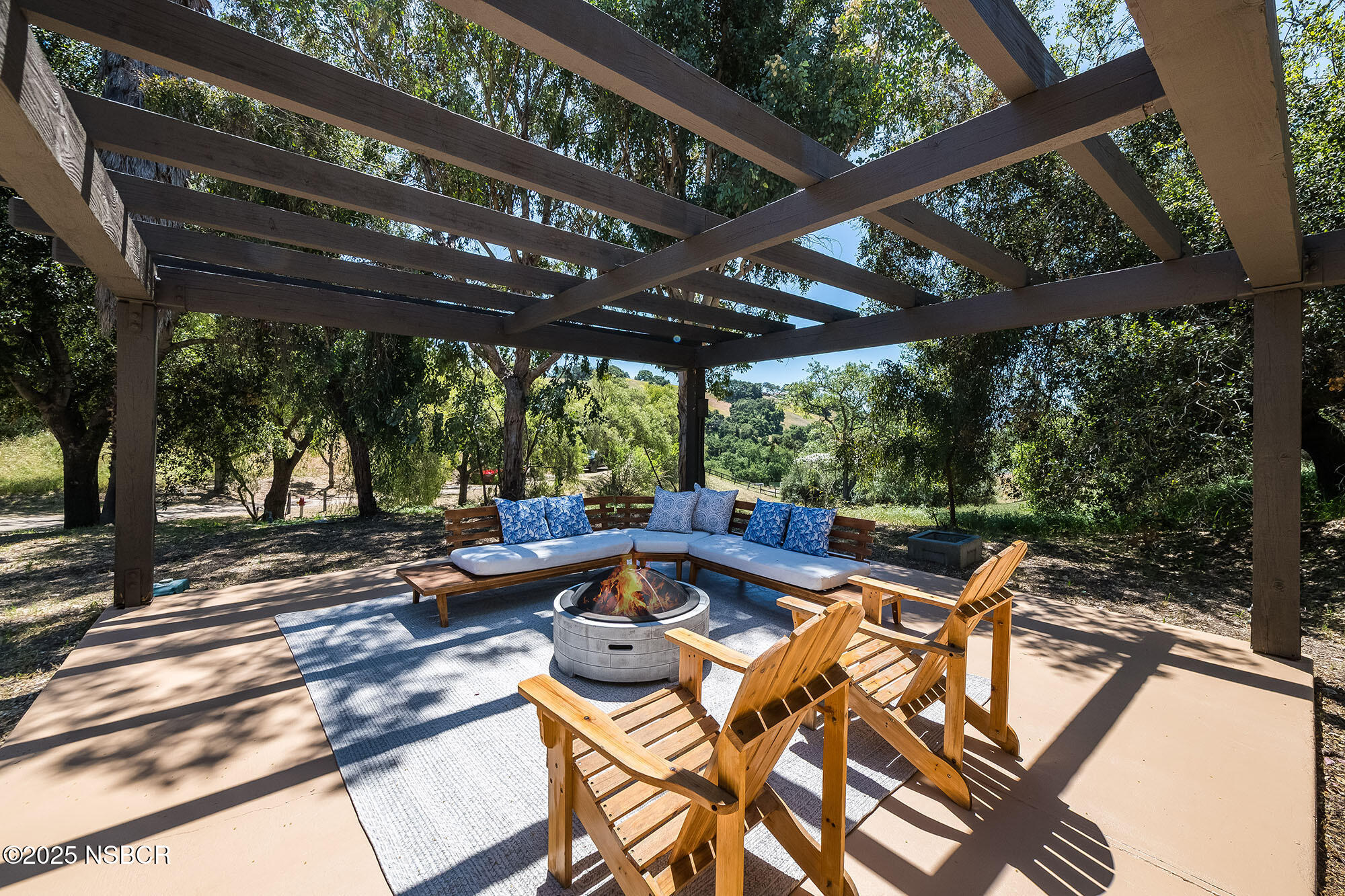3333-3349 Long Valley Road Santa Ynez, CA 93460 - Photo 83 of 97 a view of a patio with chairs and couches with wooden floor and fence