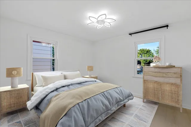 a bedroom with a bed and a chandelier