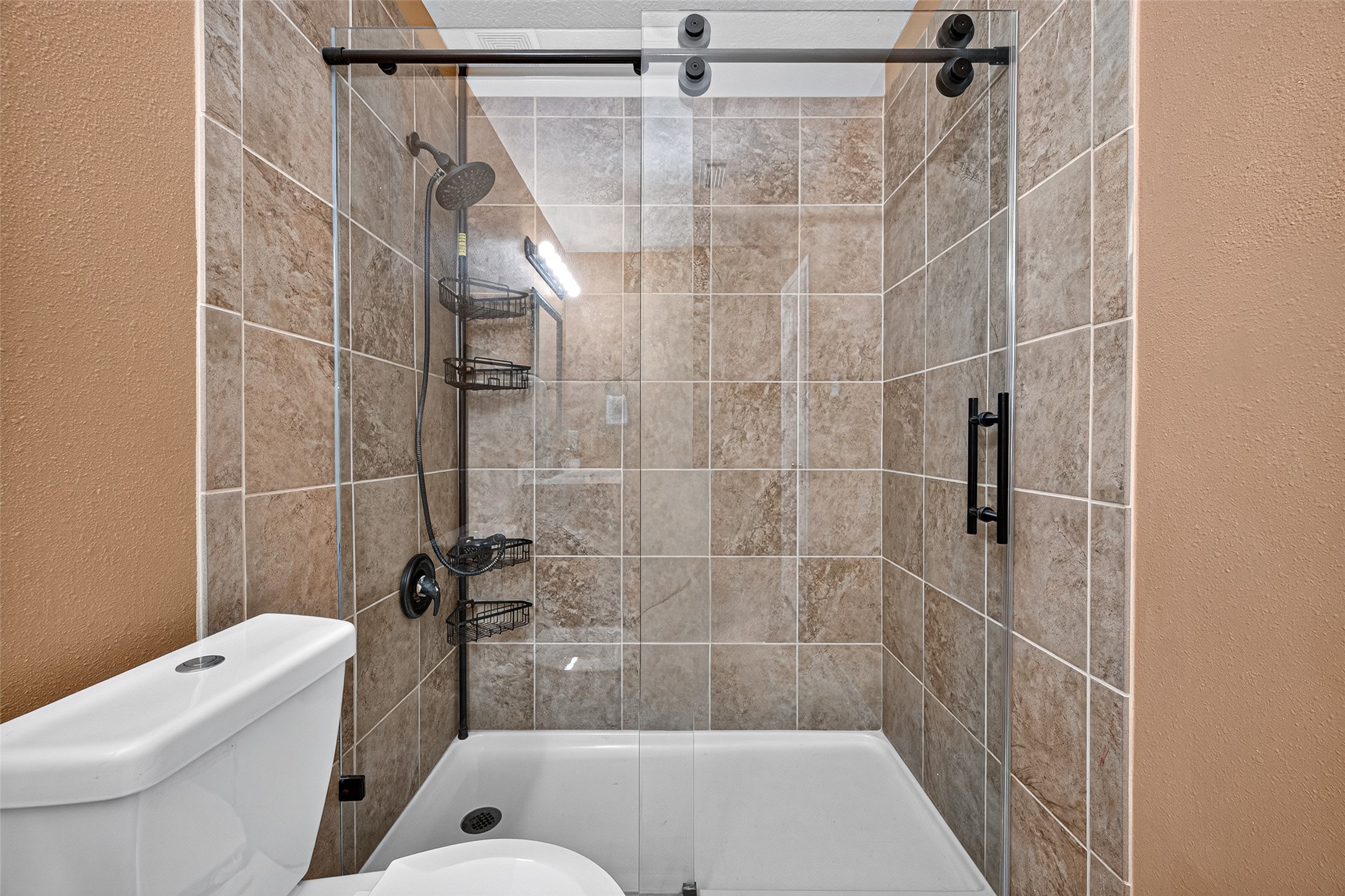 6822 Baron Gate Court Spring, TX 77379 - Photo 24 of 49 1st floor stand up shower has sliding doors and beautiful tile surround.
