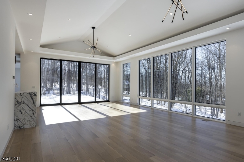 8 Juniper Pointe Trail Dunellen, NJ 08812 - Photo 20 of 37 a view of an empty room with wooden floor and a window