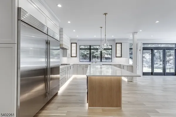 a view of a kitchen and dining room with wooden floor