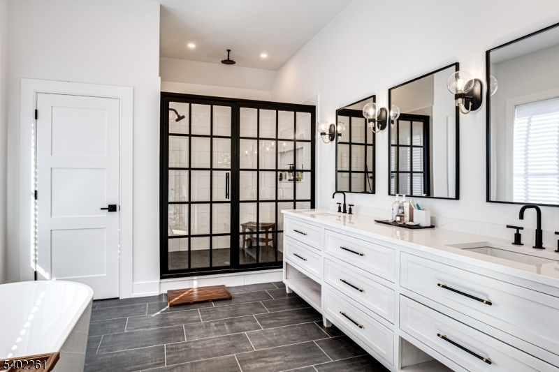 8 Juniper Pointe Trail Dunellen, NJ 08812 - Photo 5 of 37 a bathroom with a double vanity sink a mirror and a bathtub