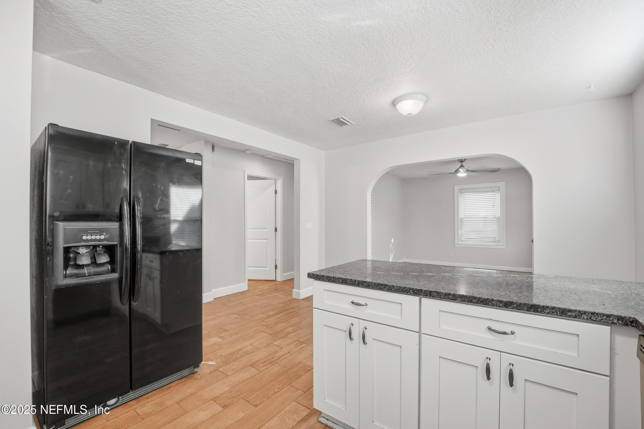 1211 Penman Road Jacksonville Beach, FL 32250 - Photo 11 of 44 a kitchen with stainless steel appliances granite countertop a refrigerator and a sink