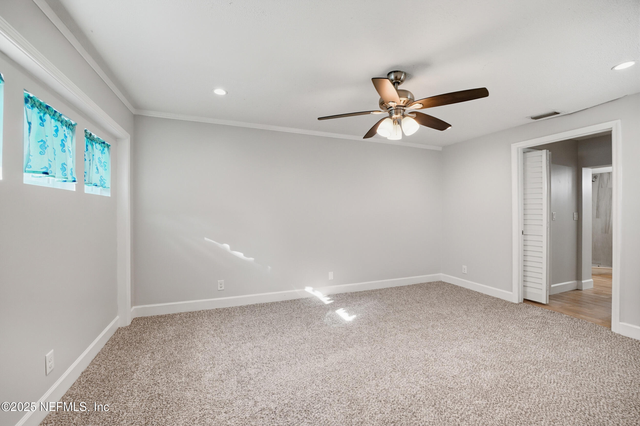 1211 Penman Road Jacksonville Beach, FL 32250 - Photo 18 of 44 wooden floor in an empty room with a window