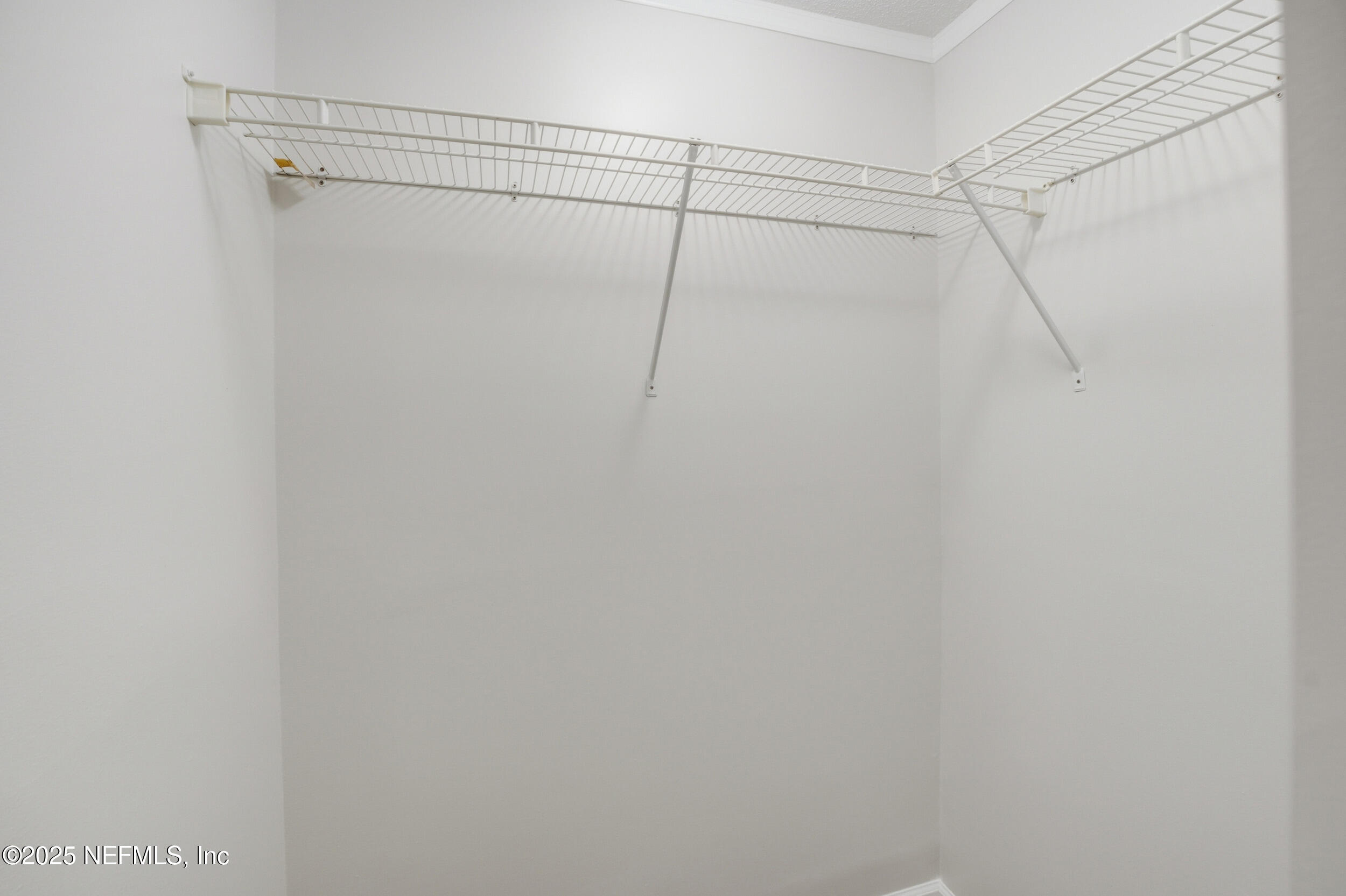 1211 Penman Road Jacksonville Beach, FL 32250 - Photo 19 of 44 a view of a room with racks on the wall