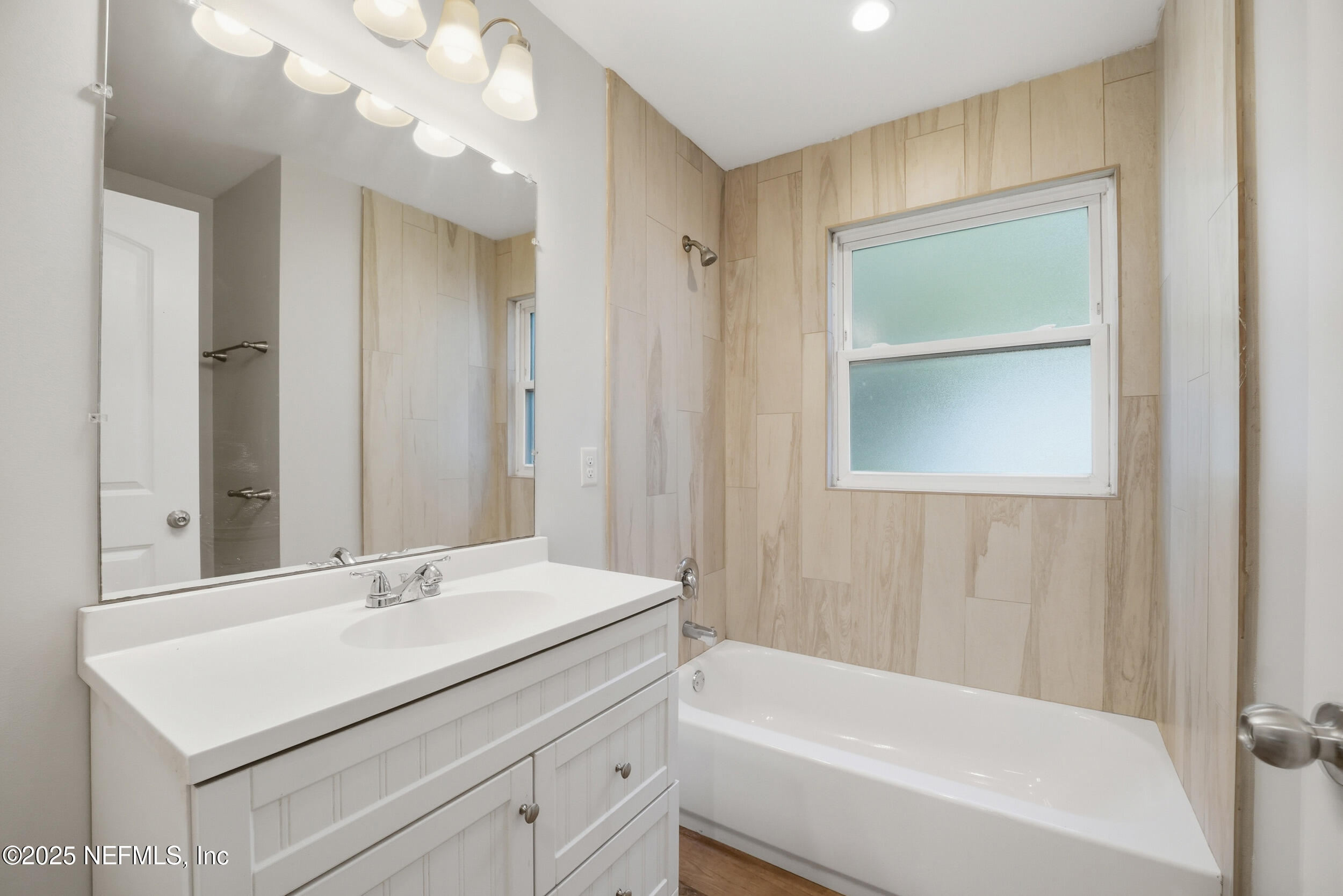 1211 Penman Road Jacksonville Beach, FL 32250 - Photo 24 of 44 a bathroom with a sink a bathtub and a mirror