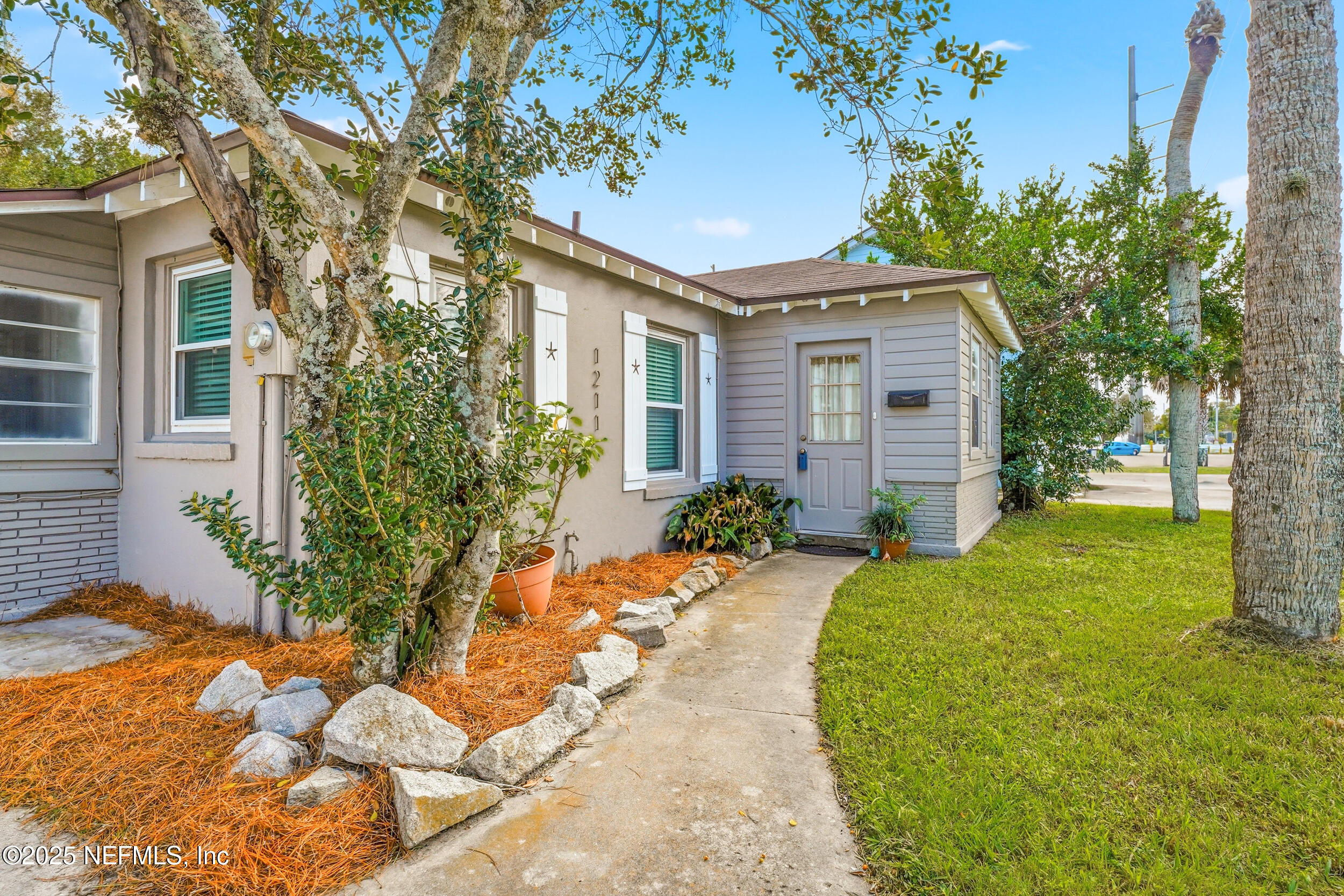 1211 Penman Road Jacksonville Beach, FL 32250 - Photo 3 of 44 a front view of a house with a yard