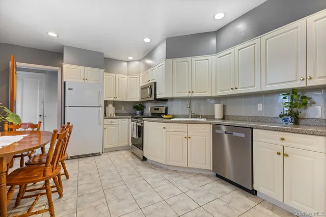 a kitchen with a white cabinets and white appliances