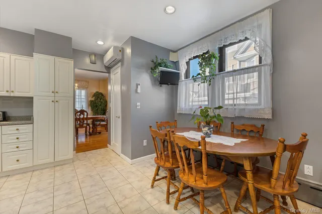 a view of a dining room with furniture and a potted plant