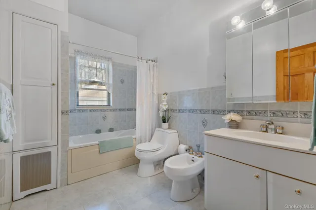 a bathroom with a sink toilet tub and shower