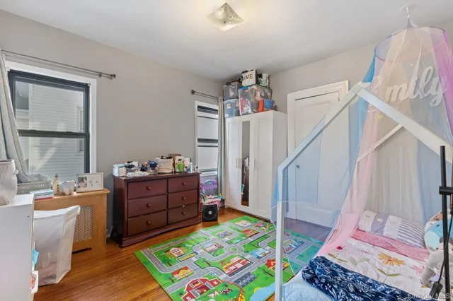a living room with furniture and a baby crib