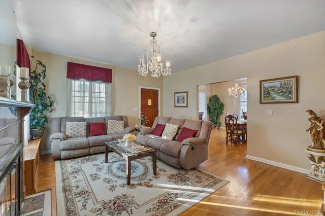 a living room with furniture and a chandelier