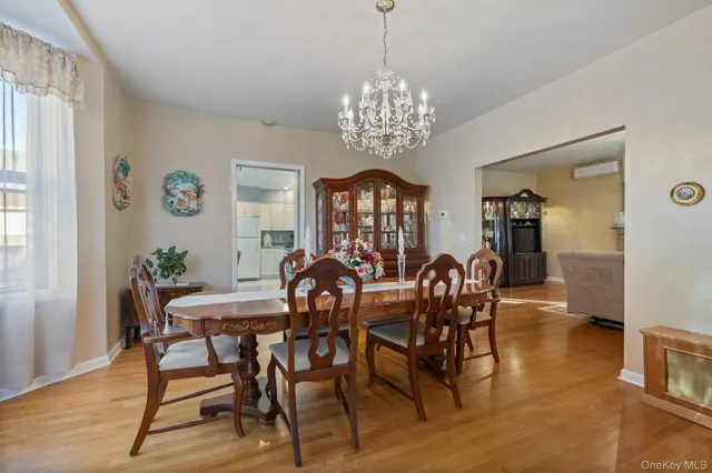 a view of a dining room with furniture a chandelier and wooden floor