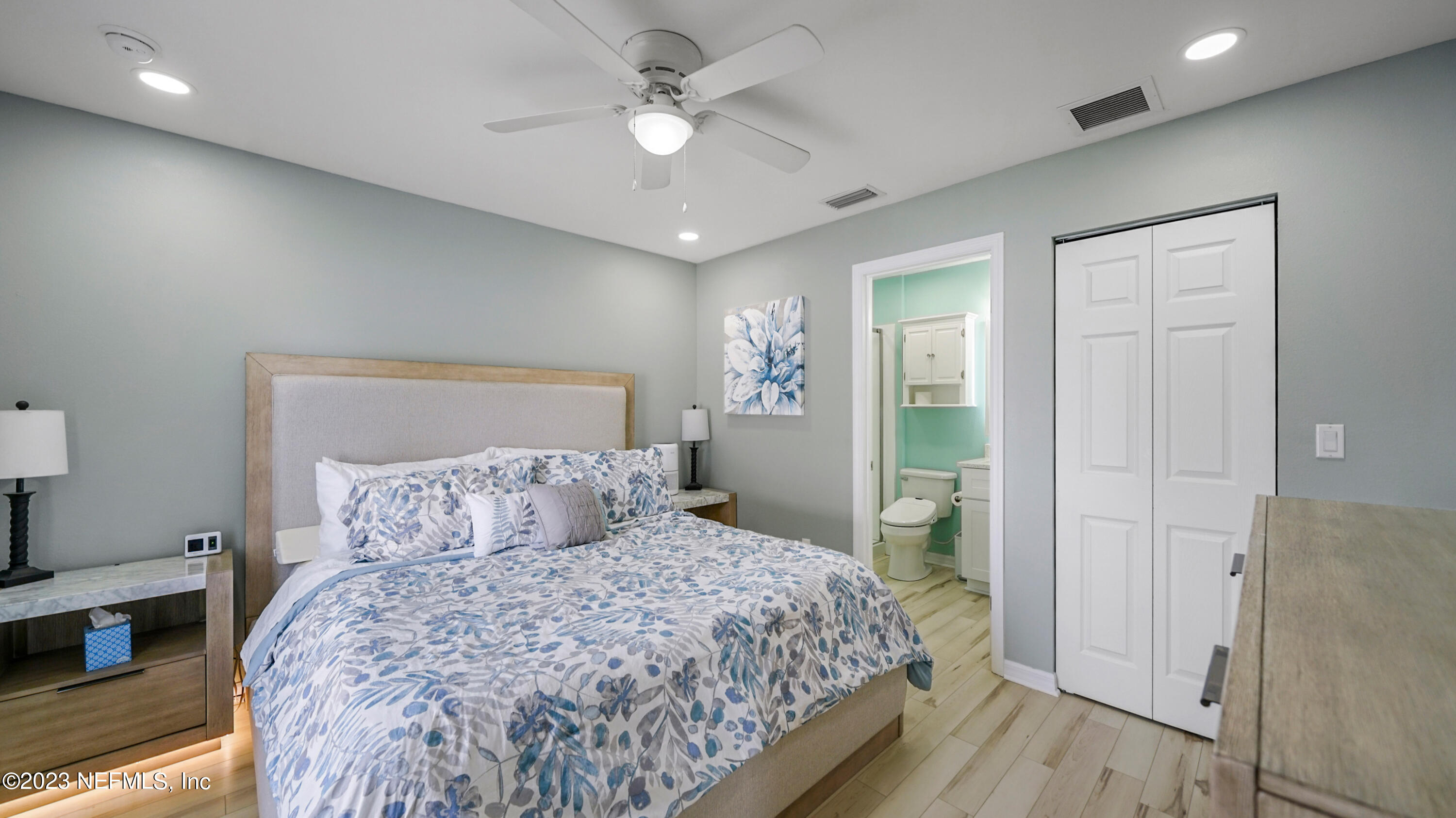 321 West Jayce Way St. Augustine, FL 32084 - Photo 14 of 34 a bedroom with a large bed and a chandelier