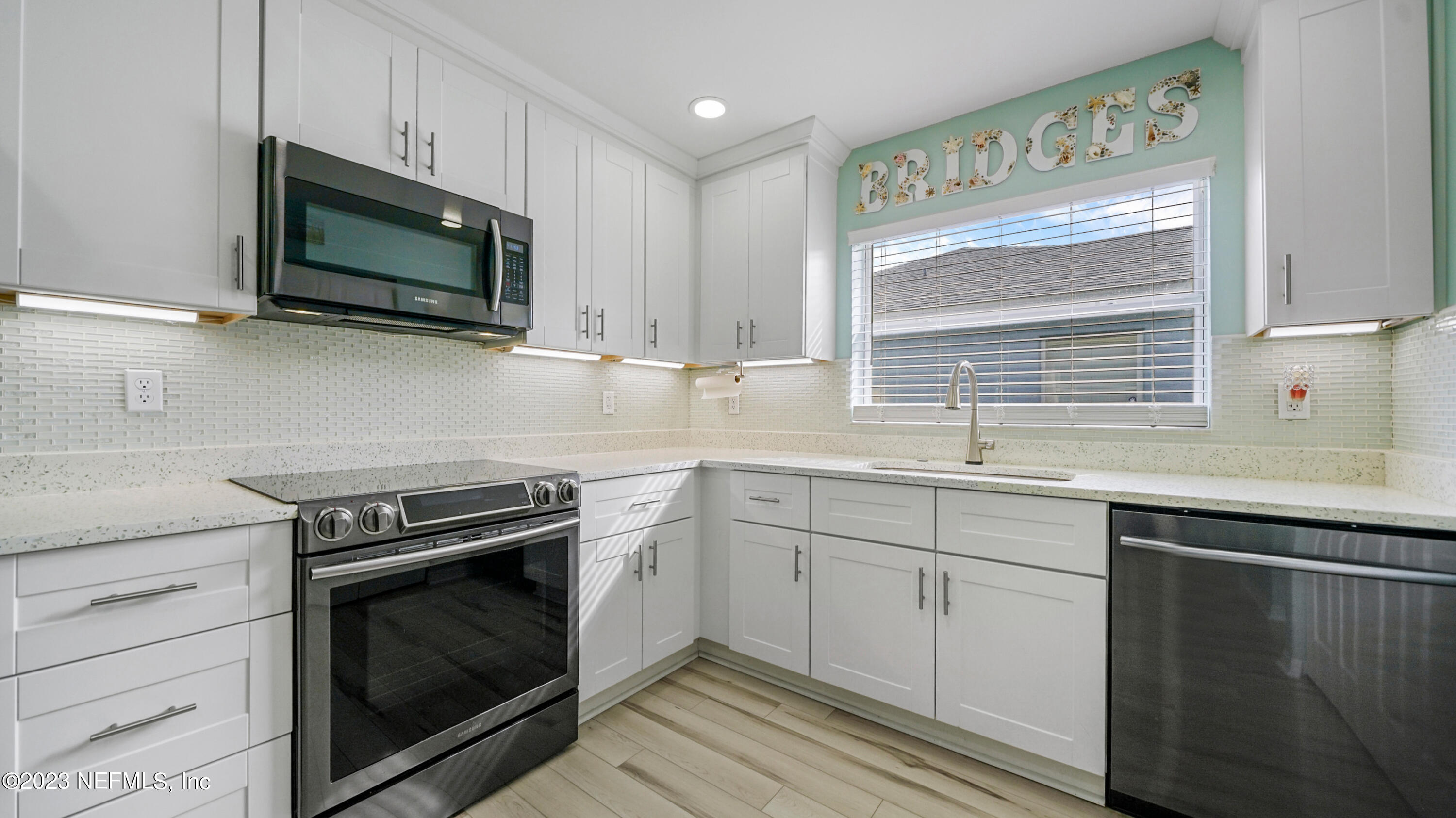 321 West Jayce Way St. Augustine, FL 32084 - Photo 3 of 34 a kitchen with stainless steel appliances a stove microwave and sink