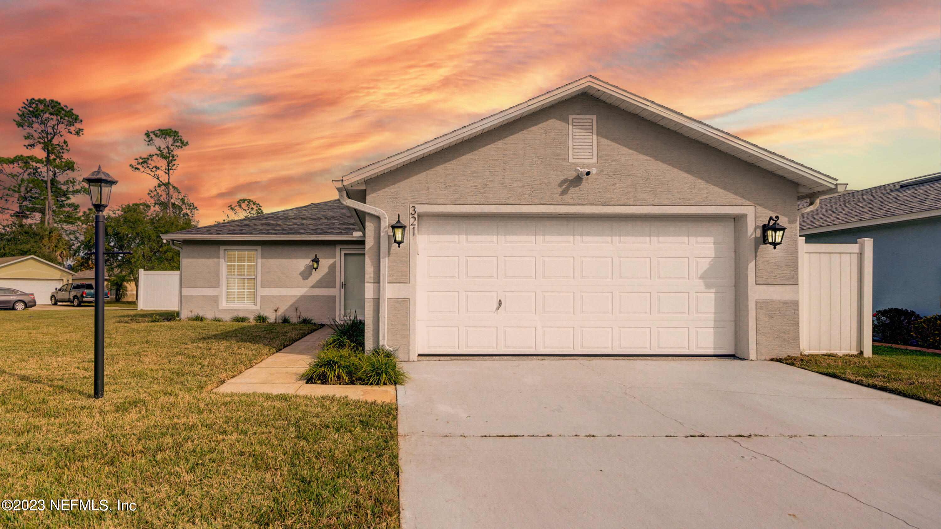 321 West Jayce Way St. Augustine, FL 32084 - Photo 7 of 34 a front view of a house with a yard and garage