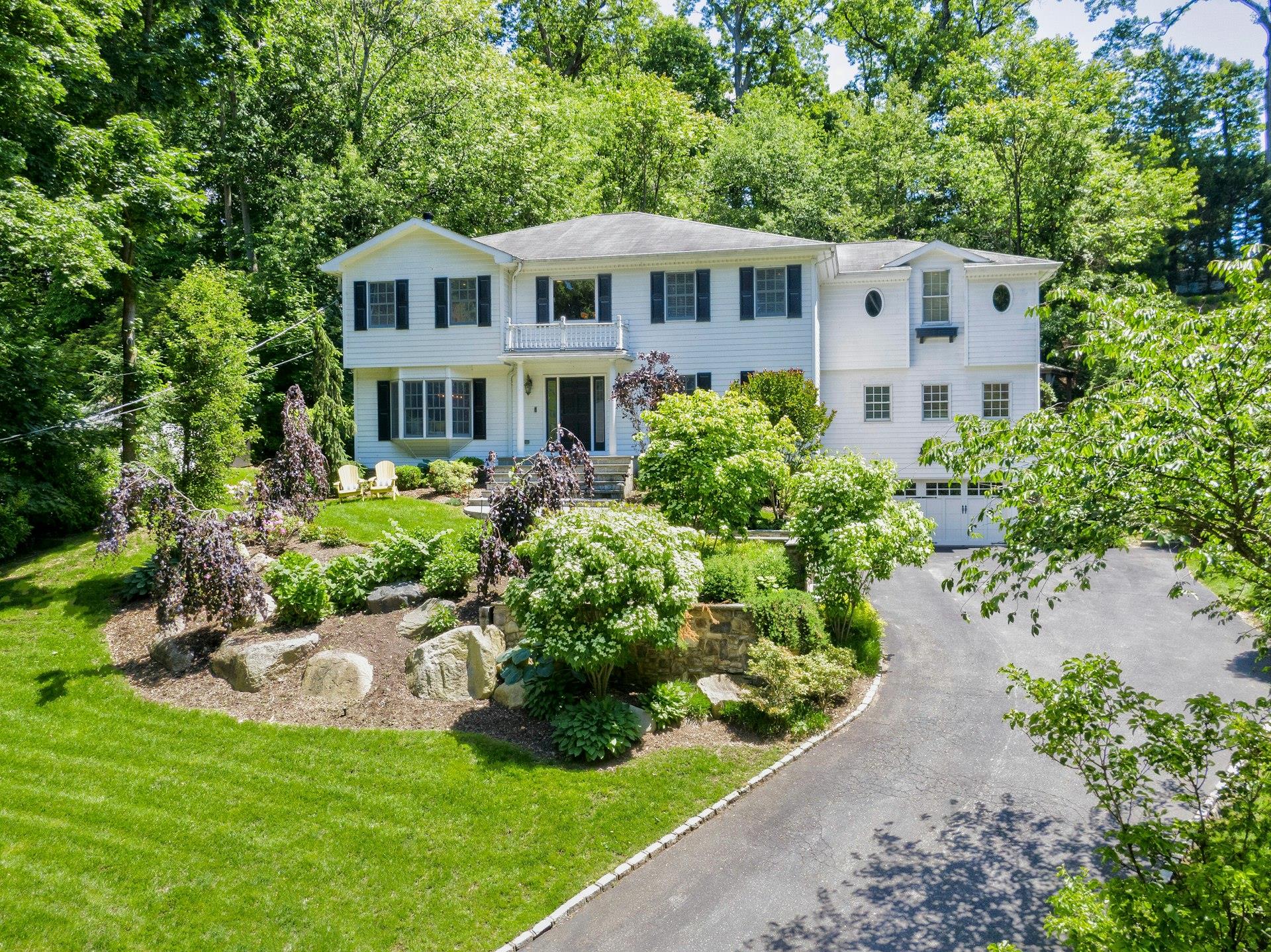 70 A Davis Road Port Washington, NY 11050 - Photo 1 of 1 a front view of a house with a garden and porch