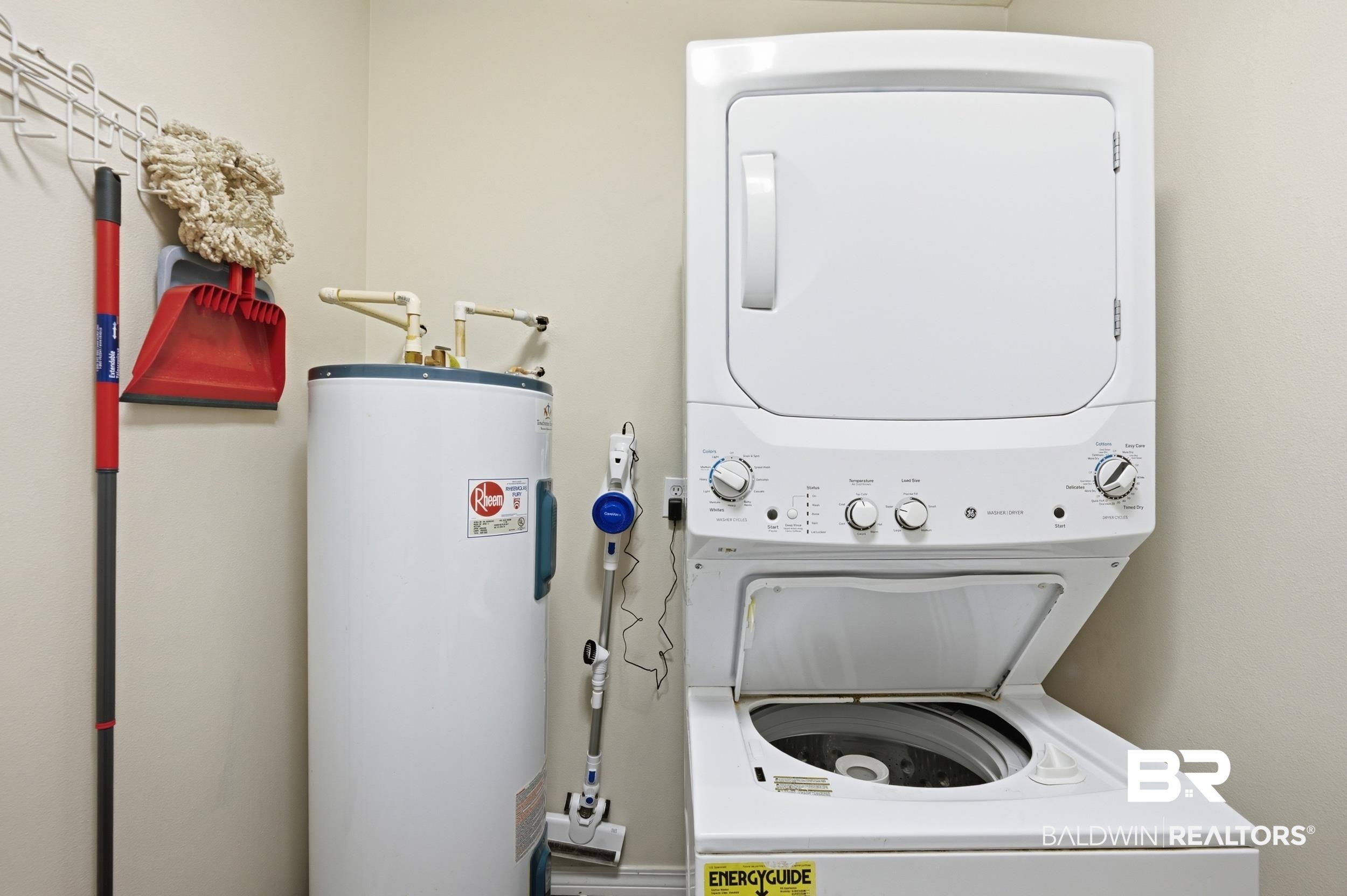 42080 Bayou Road Bay Minette, AL 36507 - Photo 23 of 43 Dedicated utility area featuring a stacked washer and dryer unit, and a water heater
