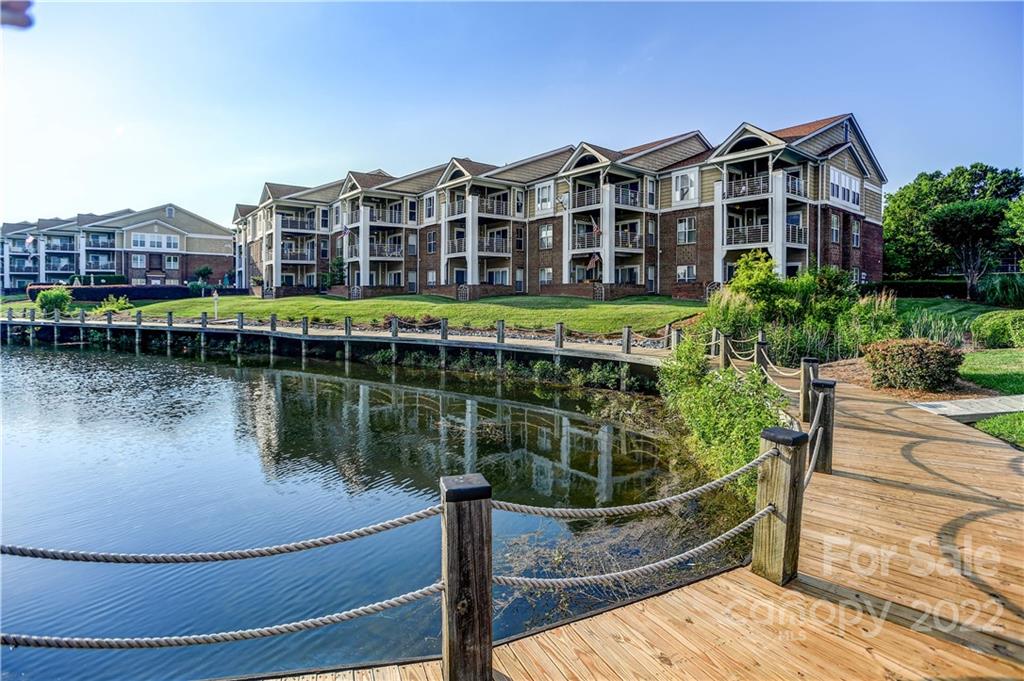 a view of a brick building next to a lake view