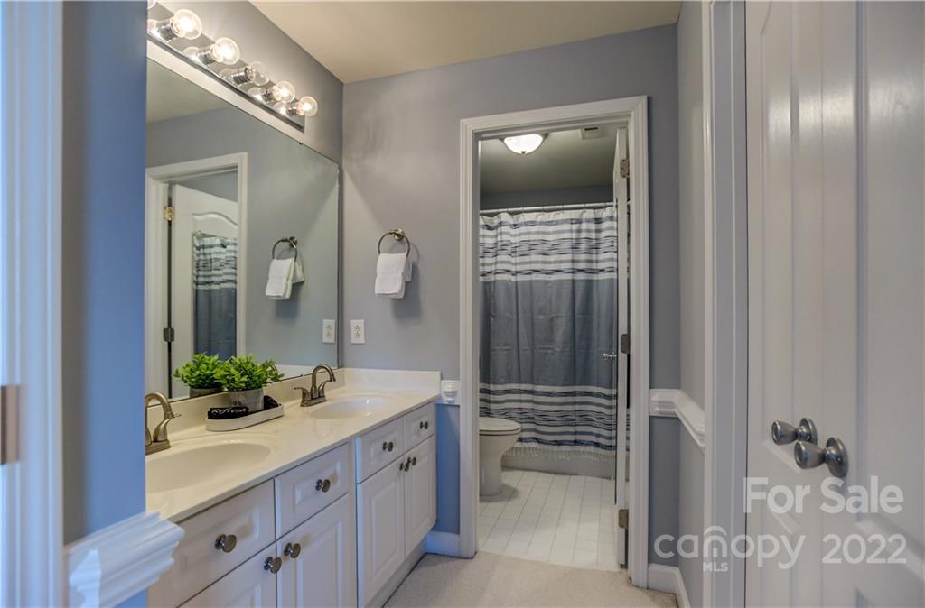 18537 Harborside Drive, Unit 9 Cornelius, NC 28031 - Photo 11 of 14 a spacious bathroom with a double vanity sink and a mirror