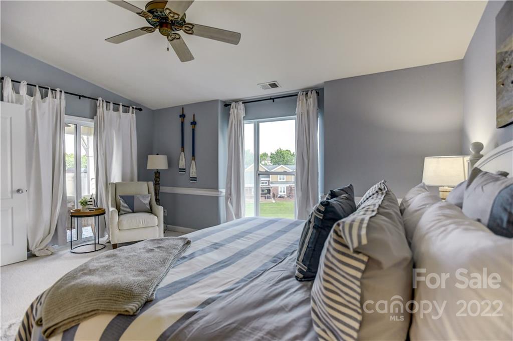 18537 Harborside Drive, Unit 9 Cornelius, NC 28031 - Photo 12 of 14 a bedroom with a bed and wooden floor