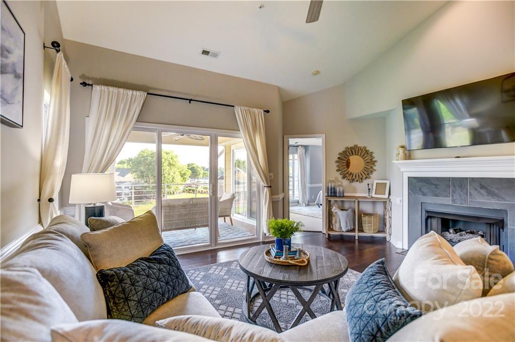 18537 Harborside Drive, Unit 9 Cornelius, NC 28031 - Photo 4 of 14 a living room with furniture and a fireplace