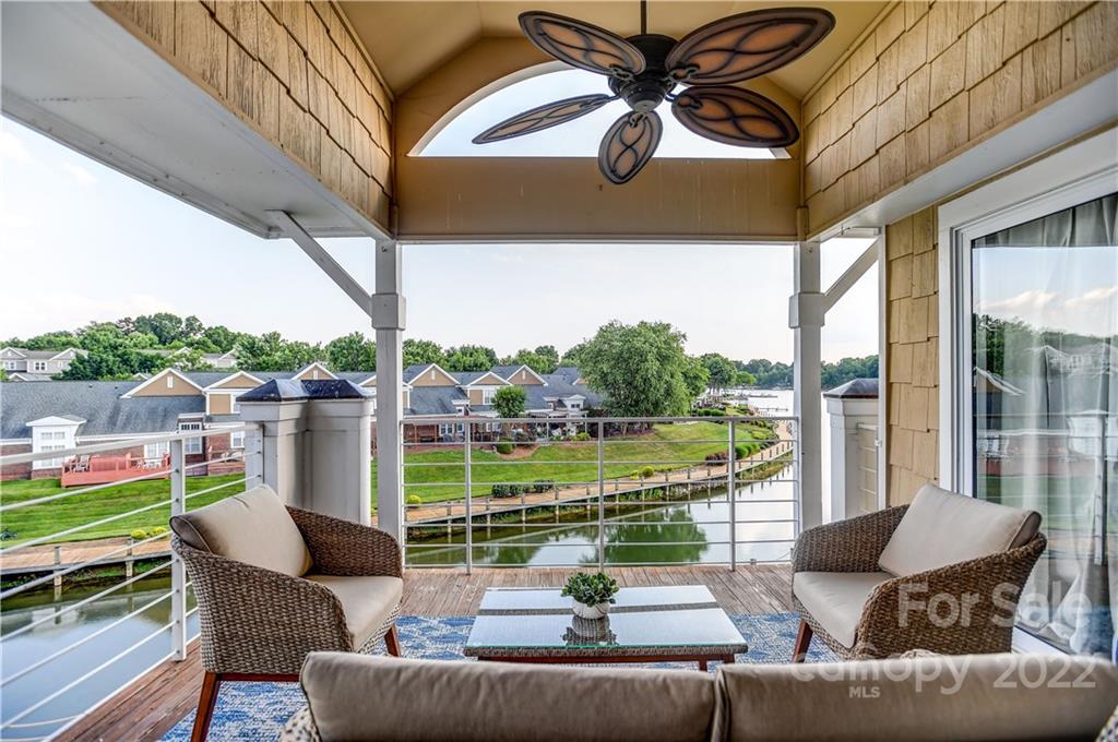 18537 Harborside Drive, Unit 9 Cornelius, NC 28031 - Photo 6 of 14 a view of a patio with couches chairs dining table and chairs