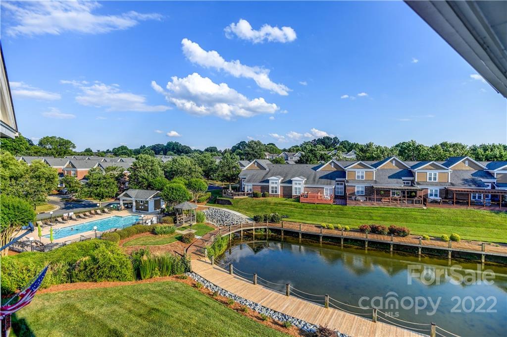 18537 Harborside Drive, Unit 9 Cornelius, NC 28031 - Photo 9 of 14 a view of a house with pool and a yard