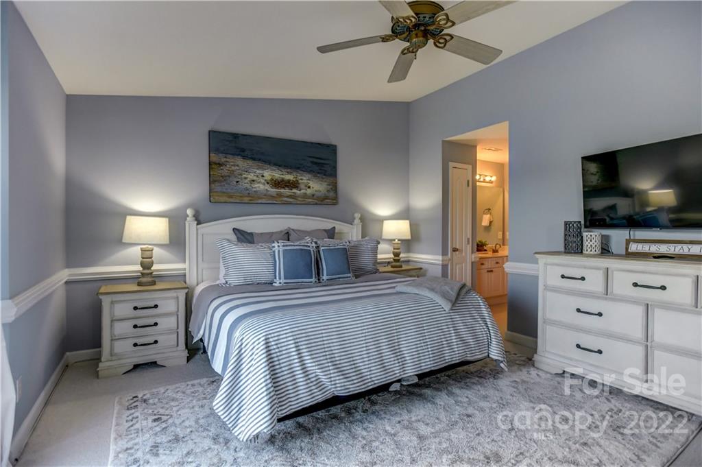 18537 Harborside Drive, Unit 9 Cornelius, NC 28031 - Photo 10 of 14 a bedroom with a bed and a flat screen tv