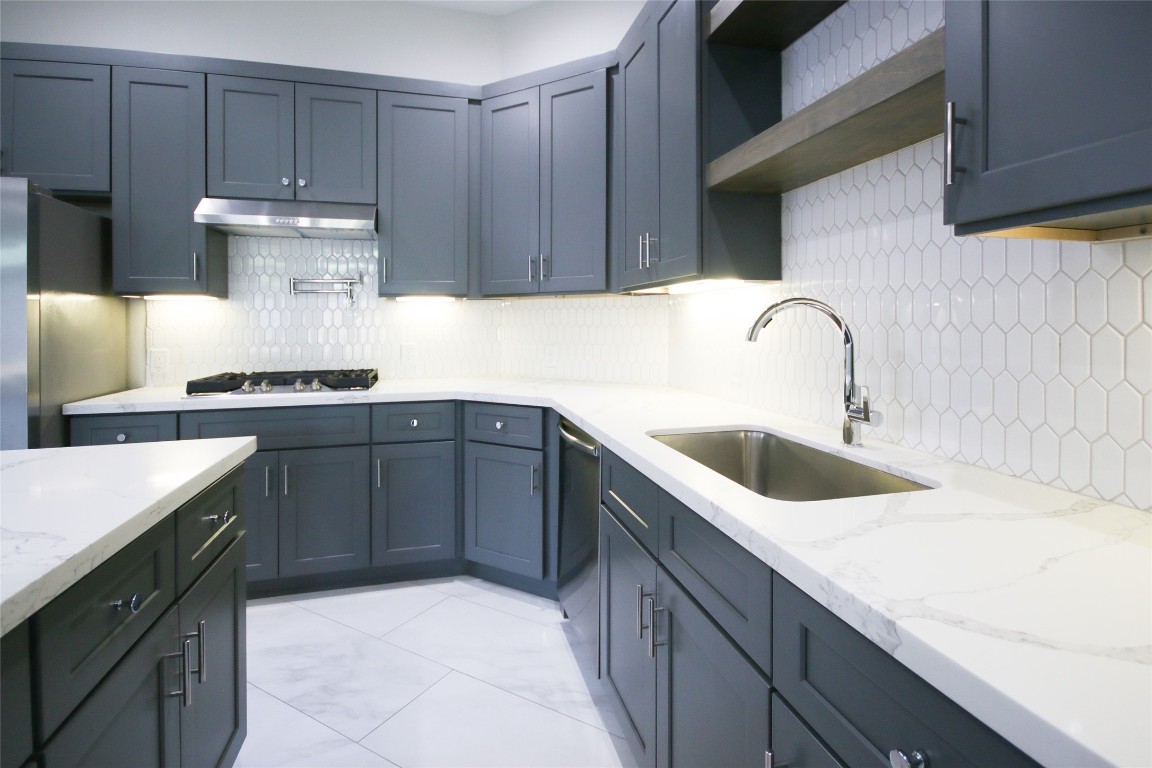 5113 Hershe Street, Unit B Houston, TX 77020 - Photo 11 of 44 a kitchen with a sink dishwasher a stove and a refrigerator