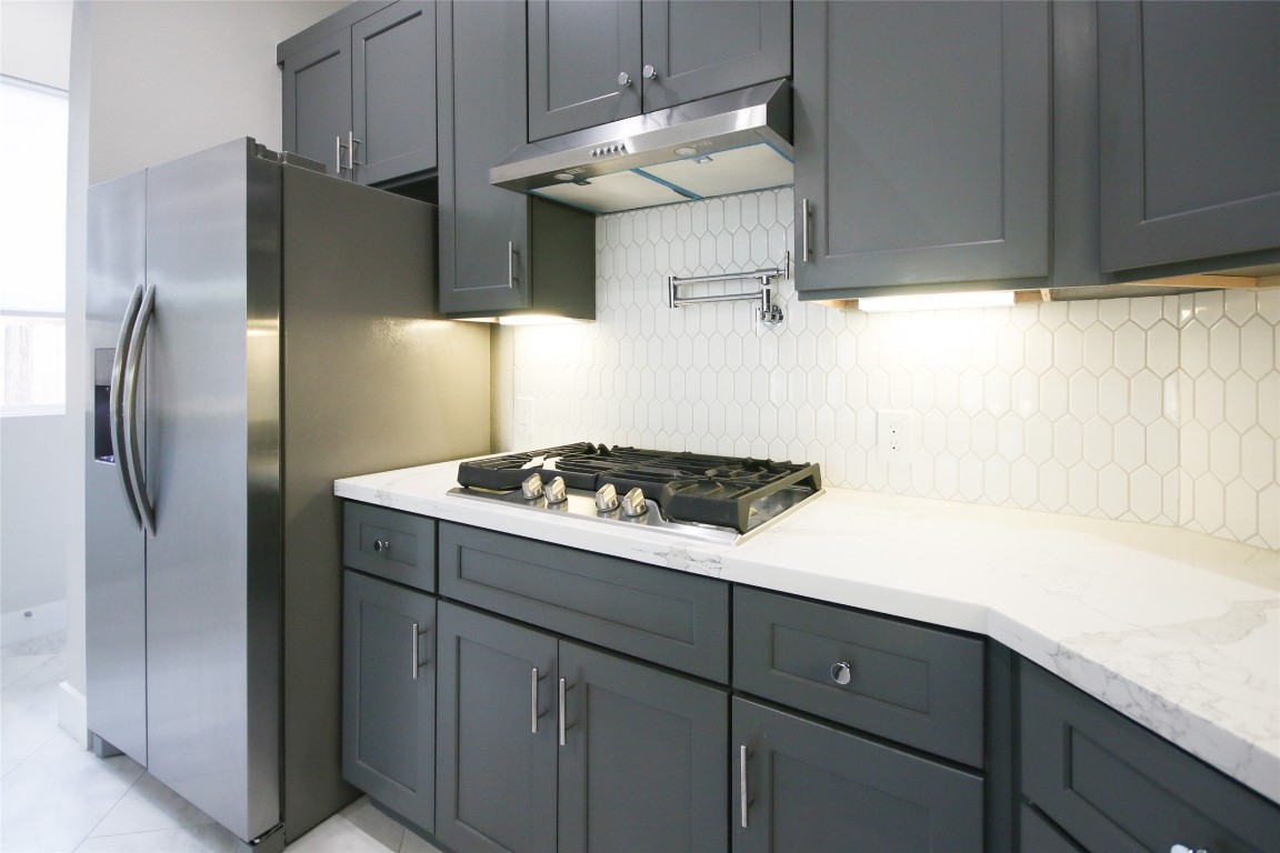 5113 Hershe Street, Unit B Houston, TX 77020 - Photo 12 of 44 a kitchen with stainless steel appliances a refrigerator and a stove