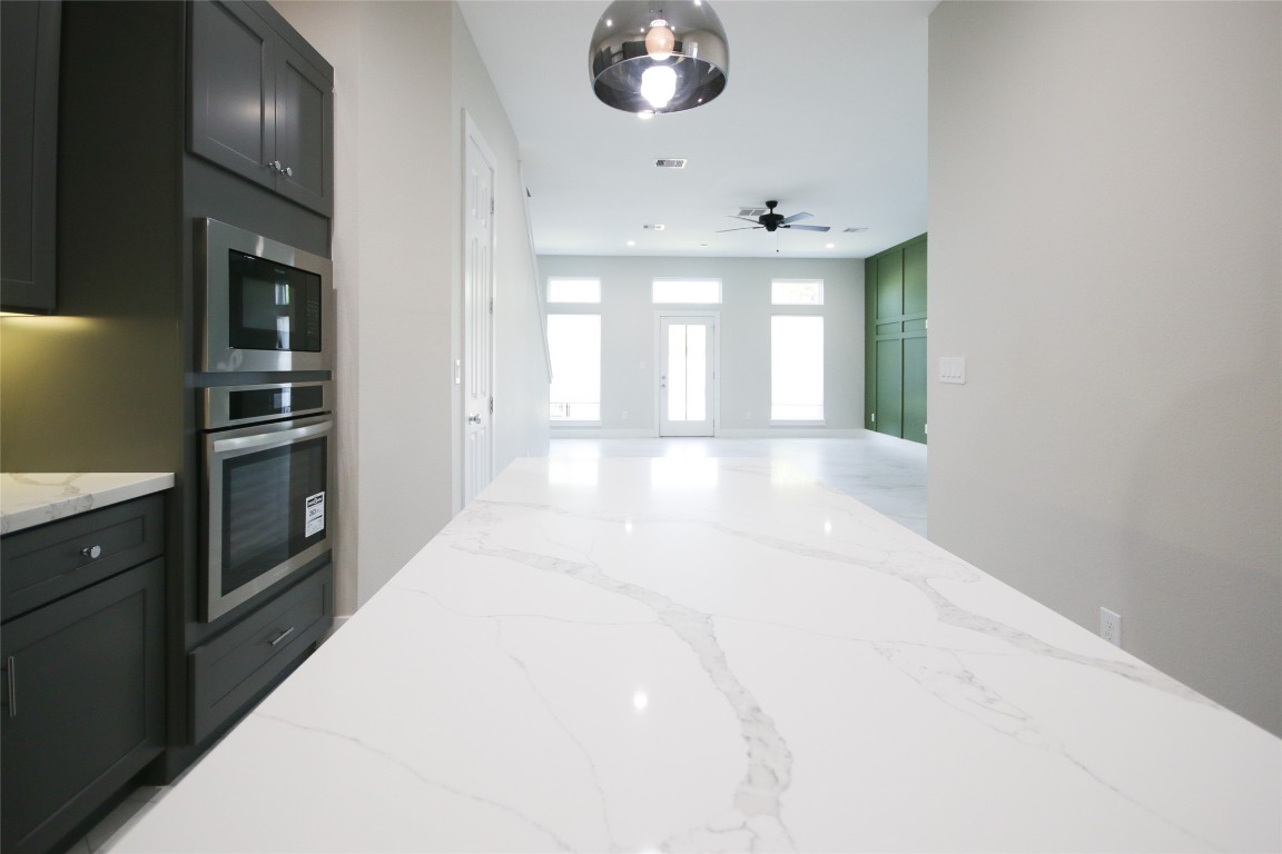 5113 Hershe Street, Unit B Houston, TX 77020 - Photo 13 of 44 a large white kitchen with granite countertop a sink and dishwasher a stove with wooden floor