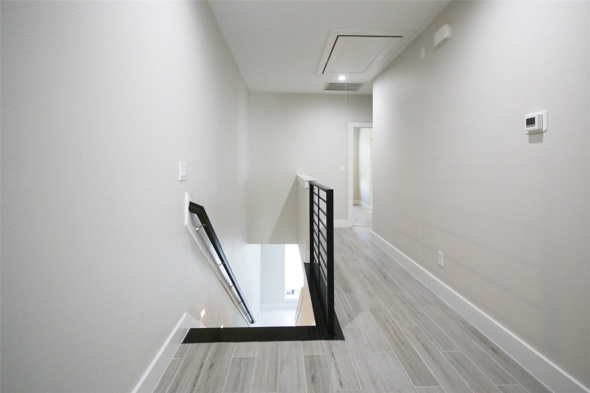 5113 Hershe Street, Unit B Houston, TX 77020 - Photo 15 of 44 a view of a hallway with wooden floor and stairs