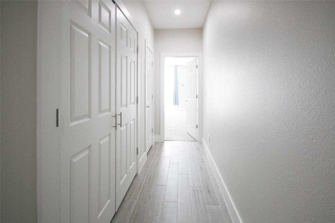 5113 Hershe Street, Unit B Houston, TX 77020 - Photo 29 of 44 a view of a hallway with wooden floor
